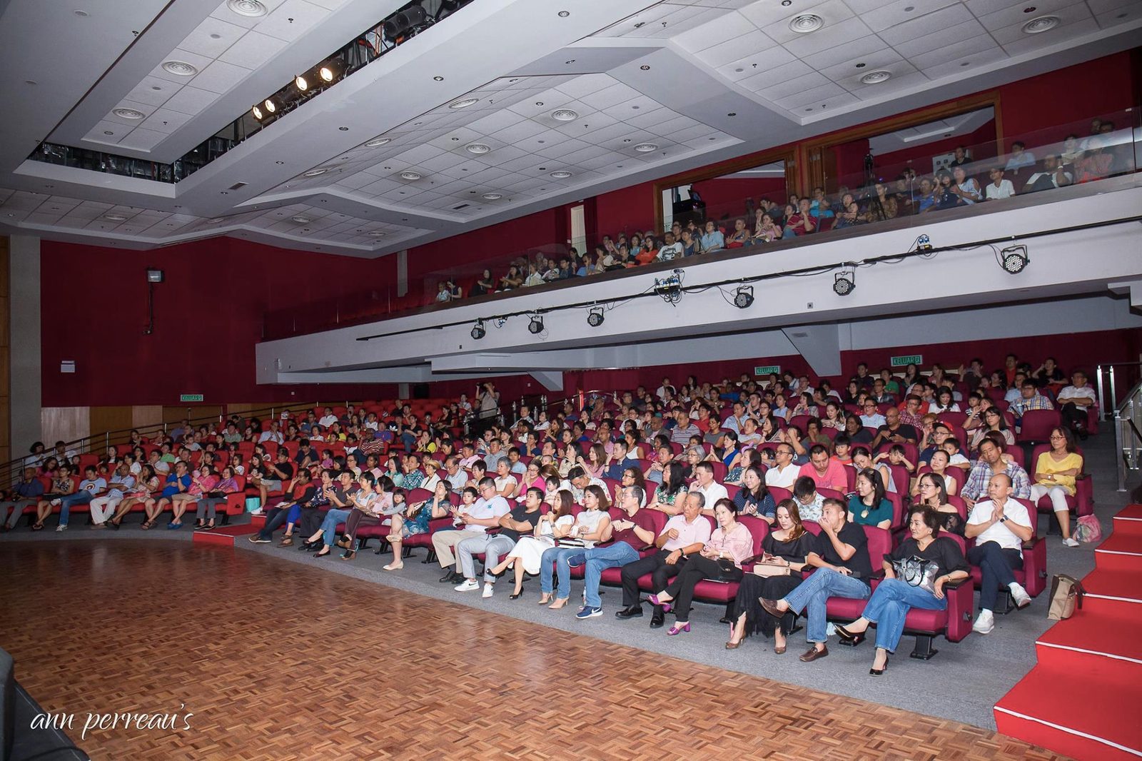 Families seated in the music hall audience